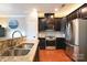 Bright kitchen featuring stainless steel appliances, granite countertops, and dark cabinetry at 3537 Hornets Nest Way # 206, Charlotte, NC 28208