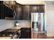 Stylish kitchen featuring stainless steel appliances and dark wood cabinetry at 3537 Hornets Nest Way # 206, Charlotte, NC 28208
