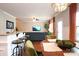 Open-concept living space with hardwood floors, bar seating, and a comfortable sofa at 3537 Hornets Nest Way # 206, Charlotte, NC 28208