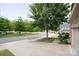 Serene street view featuring mature trees lining the road, enhancing the neighborhood's natural appeal at 3537 Hornets Nest Way # 206, Charlotte, NC 28208