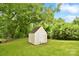 A wooden shed in a large yard surrounded by beautiful trees at 379 Sharpe St, Mooresville, NC 28115