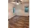 Cozy bedroom featuring wood-look flooring and natural light from two windows at 379 Sharpe St, Mooresville, NC 28115