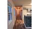 A hallway leads to an open kitchen with hardwood floors and lots of natural light at 379 Sharpe St, Mooresville, NC 28115