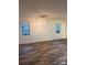 Open-concept living room featuring wood-look flooring and natural light from two windows at 379 Sharpe St, Mooresville, NC 28115