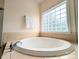 Modern soaking tub with tile surround and large window at 408 Presidio Dr, Rock Hill, SC 29732