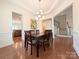 Formal dining room with tray ceiling, hardwood floors, and staircase access at 408 Presidio Dr, Rock Hill, SC 29732