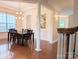 Elegant dining room with decorative chandelier, wainscoting and hardwood flooring at 408 Presidio Dr, Rock Hill, SC 29732