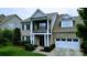 Attractive brick home with white trim, black shutters, a balcony, and an attached two-car garage at 408 Presidio Dr, Rock Hill, SC 29732