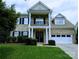 Charming two-story brick home with a well-manicured lawn, black shutters, and covered front porch at 408 Presidio Dr, Rock Hill, SC 29732
