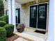 Close-up of a home's front porch with double doors, white columns, and beautiful flower display at 408 Presidio Dr, Rock Hill, SC 29732