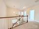Upstairs hallway with carpet and a wooden banister and railings at 408 Presidio Dr, Rock Hill, SC 29732