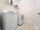 Well-lit laundry room features tile floors, shelving, and a modern washer and dryer at 408 Presidio Dr, Rock Hill, SC 29732