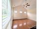 Bright living room with vaulted ceiling, hardwood floors and transom windows for ample lighting at 408 Presidio Dr, Rock Hill, SC 29732