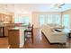 Spacious living room with hardwood floors, large windows, and open layout to kitchen at 408 Presidio Dr, Rock Hill, SC 29732