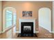 Living room with charming fireplace and arches and filled with natural light from many windows at 408 Presidio Dr, Rock Hill, SC 29732