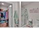 Bathroom featuring a tiled shower with glass door and an adjacent walk-in closet for added convenience at 410 Apex Cir, Shelby, NC 28152