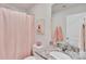 Charming bathroom featuring a granite countertop, framed art and a decorative pink shower curtain at 410 Apex Cir, Shelby, NC 28152