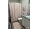 Well-lit bathroom featuring a vanity with a granite countertop and a patterned shower curtain at 410 Apex Cir, Shelby, NC 28152