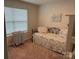 Comfortable bedroom with a cozy bed, floral bedding, and ample natural light at 410 Apex Cir, Shelby, NC 28152