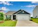Charming single-story home with a well-manicured lawn and two-car garage at 410 Apex Cir, Shelby, NC 28152
