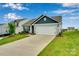 Attractive home with a concrete driveway and landscaping at 410 Apex Cir, Shelby, NC 28152