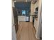 Modern kitchen with stainless steel appliances, white cabinets, and hardwood flooring at 410 Apex Cir, Shelby, NC 28152