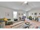 Bright and spacious living room with a ceiling fan and access to the dining area at 410 Apex Cir, Shelby, NC 28152
