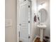 Powder room features a pedestal sink, modern fixtures, and an interior door at 4107 Park South Station Blvd, Charlotte, NC 28210