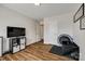 Bonus room featuring wood floors, TV, and exercise equipment at 4107 Park South Station Blvd, Charlotte, NC 28210