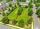 Aerial view of community park with lush green grass, mature trees and black fencing in a suburban neighborhood at 4107 Park South Station Blvd, Charlotte, NC 28210