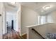 Hallway with wood floors, neutral walls, and access to multiple rooms at 4107 Park South Station Blvd, Charlotte, NC 28210