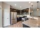 Stylish kitchen with stainless steel appliances, granite counters, and dark wood cabinetry at 4107 Park South Station Blvd, Charlotte, NC 28210