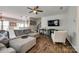 Spacious living room with hardwood floors, gray sofa, white rocking chair, and flat screen TV at 4107 Park South Station Blvd, Charlotte, NC 28210
