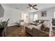 Comfortable living room with hardwood floors, large gray sectional, and white rocking chair at 4107 Park South Station Blvd, Charlotte, NC 28210