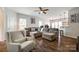 Bright living room with hardwood floors, large gray sectional, and view of the kitchen bar at 4107 Park South Station Blvd, Charlotte, NC 28210
