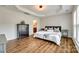 Spacious main bedroom with tray ceilings, wood floors, and ensuite access at 4107 Park South Station Blvd, Charlotte, NC 28210