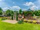 Community playground with modern play structures and seating, surrounded by beautiful landscaping, great for families at 4107 Park South Station Blvd, Charlotte, NC 28210