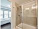 Tiled shower with glass door featuring multiple shower heads and a view into the bedroom at 4107 Park South Station Blvd, Charlotte, NC 28210