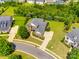 Aerial view of a traditional brick home with mature trees, lush landscaping, and a well-manicured lawn at 4220 Thames Cir, Fort Mill, SC 29715