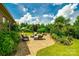 Inviting back patio featuring a stone paver, lounge chairs, and manicured lush yard, great for relaxing at 4220 Thames Cir, Fort Mill, SC 29715