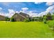 Lush backyard with green lawn of a beautiful brick home; a serene outdoor space for relaxation and recreation at 4220 Thames Cir, Fort Mill, SC 29715