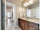 Bathroom featuring a granite vanity, wood cabinets, and tile flooring with a view of a bedroom at 4220 Thames Cir, Fort Mill, SC 29715