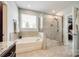 Bright bathroom with soaking tub, glass-enclosed shower, and neutral tones, offering a spa-like experience at 4220 Thames Cir, Fort Mill, SC 29715