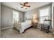 Comfortable bedroom with neutral walls, two windows, and a ceiling fan at 4220 Thames Cir, Fort Mill, SC 29715