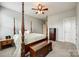 Spacious bedroom featuring a four-poster bed, ceiling fan, and ample natural light at 4220 Thames Cir, Fort Mill, SC 29715