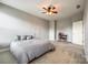 Spacious bedroom featuring a ceiling fan, neutral colors, and carpeted floor with a comfortable queen bed at 4220 Thames Cir, Fort Mill, SC 29715