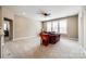 Open bonus room with comfortable seating, neutral carpet, and natural light from large windows at 4220 Thames Cir, Fort Mill, SC 29715