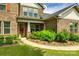 Welcoming home entrance with beautiful landscaping, a charming front door, and brick facade at 4220 Thames Cir, Fort Mill, SC 29715