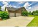 Spacious three-car garage with brick facade and ample parking space, nestled within a beautifully landscaped yard at 4220 Thames Cir, Fort Mill, SC 29715