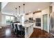 Modern kitchen with a large island, granite countertops, pendant lighting, and stainless steel appliances at 4220 Thames Cir, Fort Mill, SC 29715